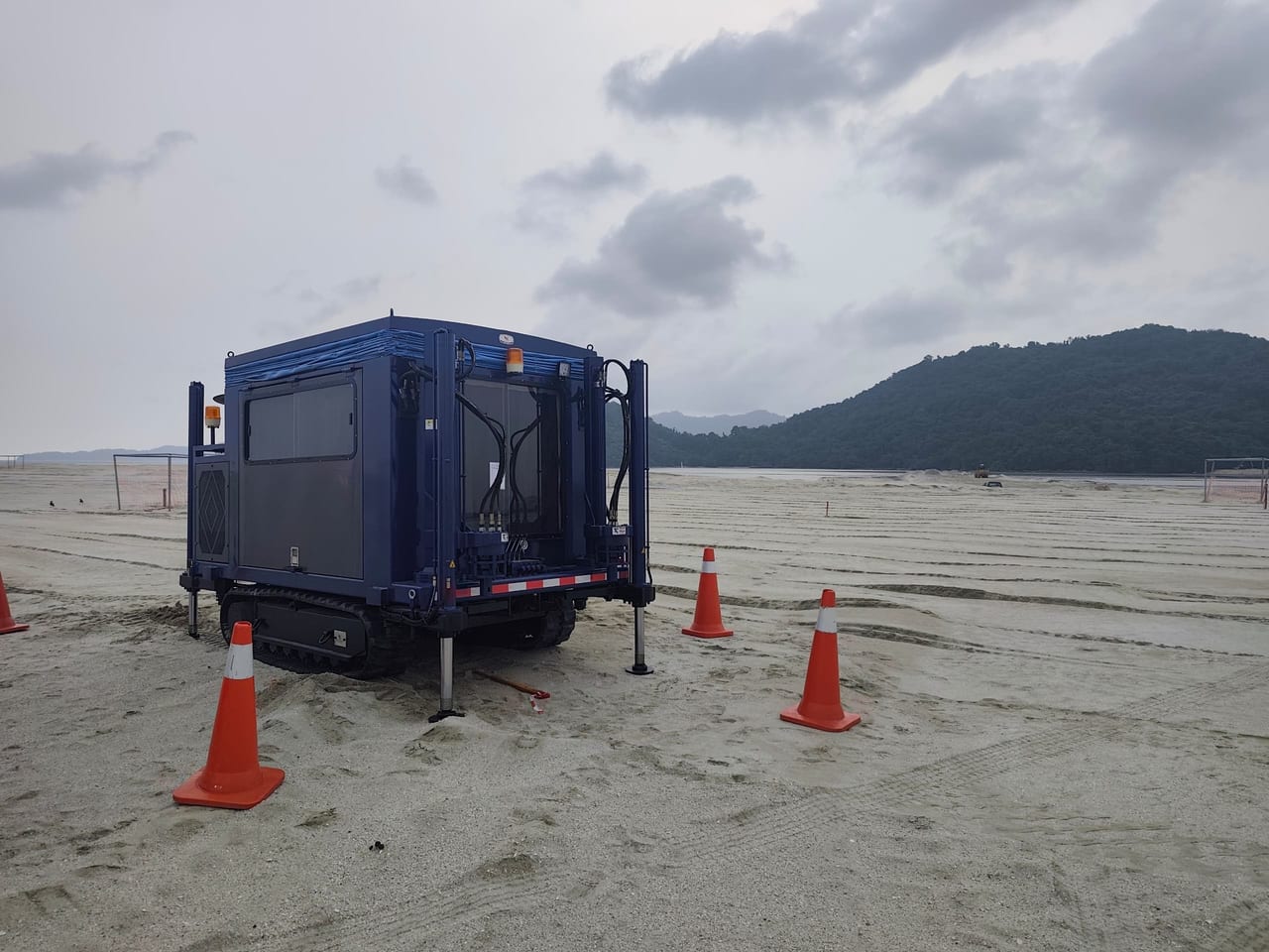 NattestGeo crawler CPT rig on site, surrounded by safety cones